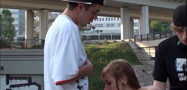  Cum in the mouth of a hot blonde teen girl in a public street sex threesome by a railway with 2 young guys doing blowjob cock sucking and vaginal penetration sexual intercourse with casual spectators watching this crazy screwing adventure